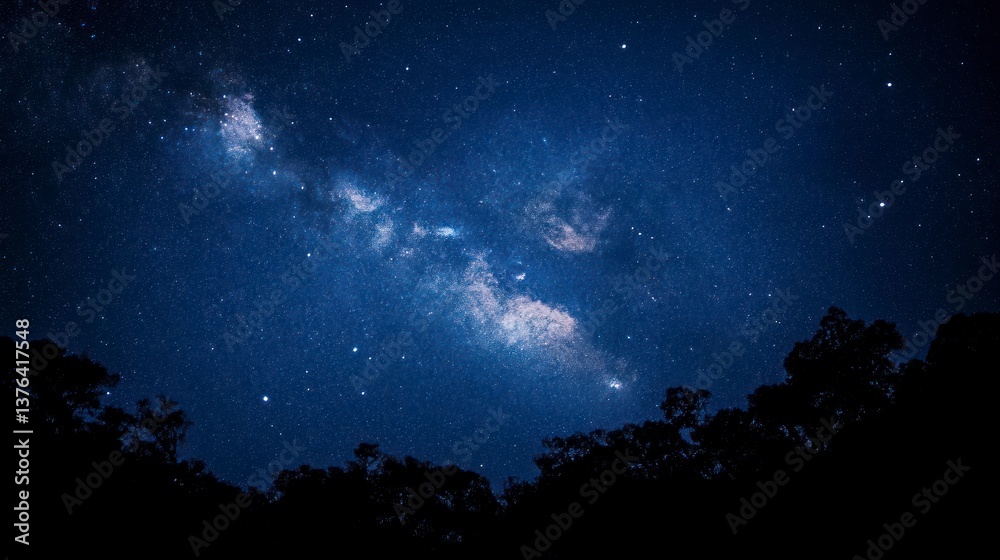 Milky Way Galaxy Over Trees in Dark Blue Night Sky Milky Way Galaxy Over Trees in Dark Blue Night Sky