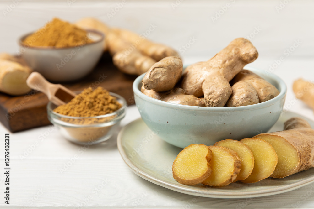 Fototapeta premium Fresh ginger on wooden background. Dry ginger. Sliced ​​ginger with honey and lemon. Ginger root. Traditional alternative medicine, healing tea for immunity. Seasoning and spices concept. Copy space.