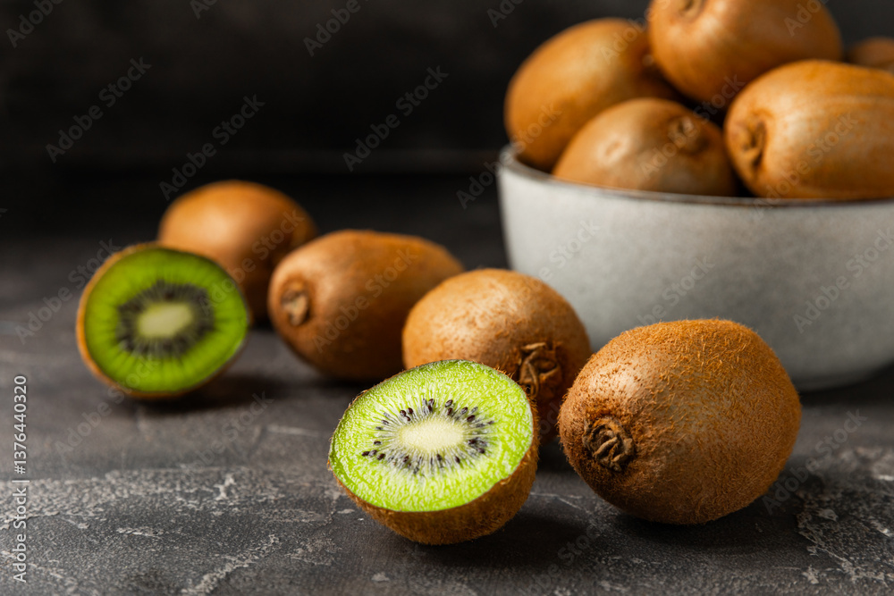 Kiwi on wooden background. Whole fruit and slices pieces of green kiwi on table. fresh ripe juicy kiwi. Tropical fruit. Organic fruit. Healthy eating. Space for text. Copy space