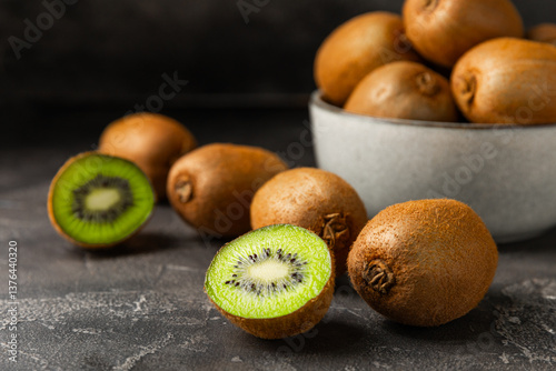 Obraz na płótnie Kiwi on wooden background. Whole fruit and slices pieces of green kiwi on table. fresh ripe juicy kiwi. Tropical fruit. Organic fruit. Healthy eating. Space for text. Copy space w salonie