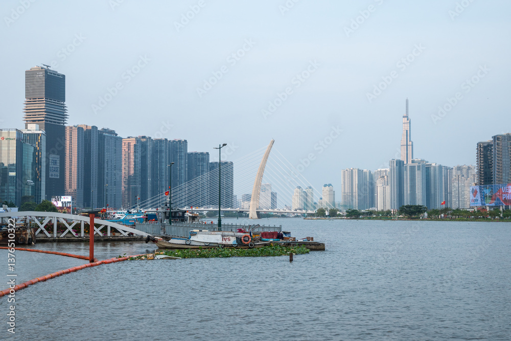 Fototapeta premium A vibrant cityscape with a captivating waterfront and impressive skyscrapers, Ho Chi Minh City
