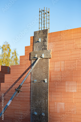 Installation of formwork for columns on the pediment of a residential building. Formwork works. Construction.