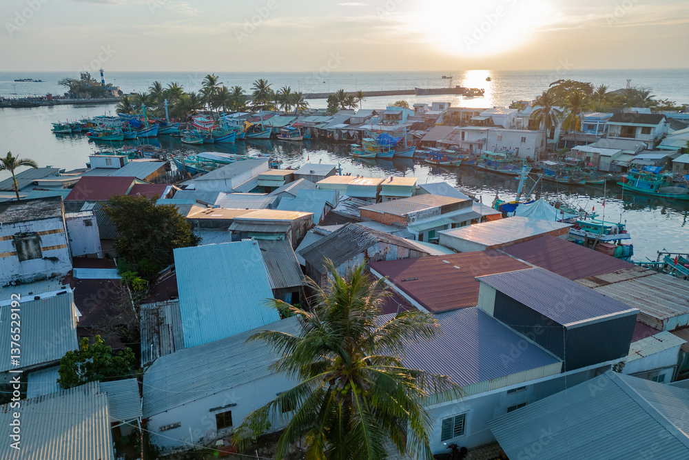 Fototapeta premium A Beautiful Serene Sunset Over the Calm Sea with Boats Sail Gently Across the Waters Surface, Phu Quoc, Vietnam