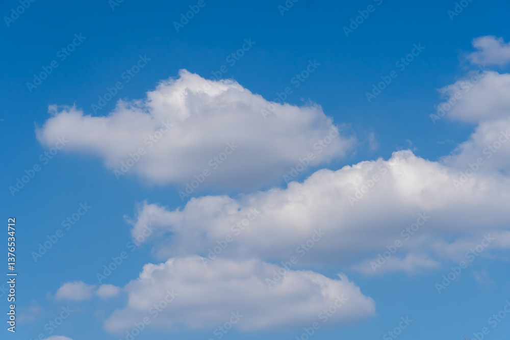 Blue sky and white clouds of nature background. Some different shapes of cloudscape. Cumulus and atmospheric mood. Contrasts weather is frowning and sunny. Blue sky and white clouds of nature background. Some different shapes of cloudscape. Cumulus and atmospheric mood. Contrasts weather is frowning and sunny.