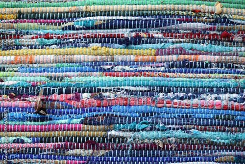 Colorful woven rag rug texture, handmade fabric background 