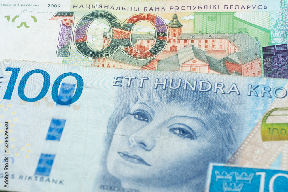 Fototapeta premium 100 Belarusian ruble and 100 Swedish krone banknotes. International trade concept