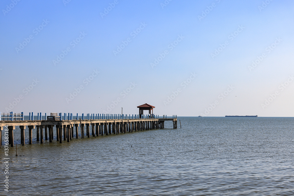 Fototapeta premium Pier at the sea, jetty and sea in sun light.