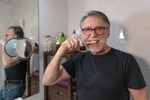 Obraz na płótnie An older man grooms himself and goes through his morning routine and undergoes men's beauty treatments. w salonie