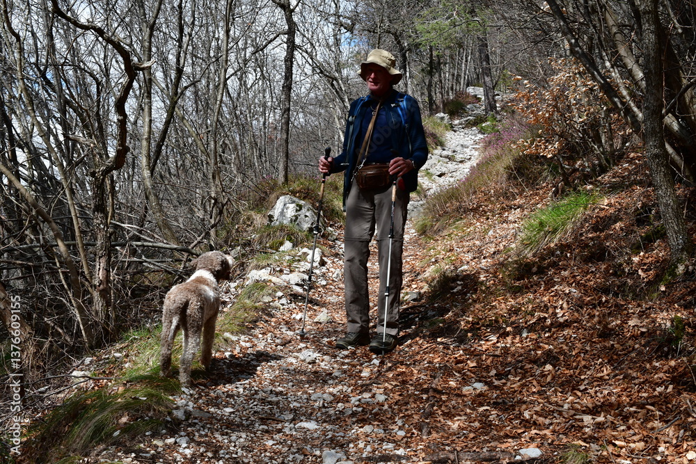 Mann und sein Lagotto Romagnolo Hund wandern im Trentino