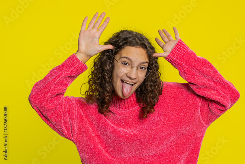 Photos Caucasian teenager girl in blouse showing tongue making faces at camera, fooling around, joking, aping with silly face, teasing, bullying, abuse