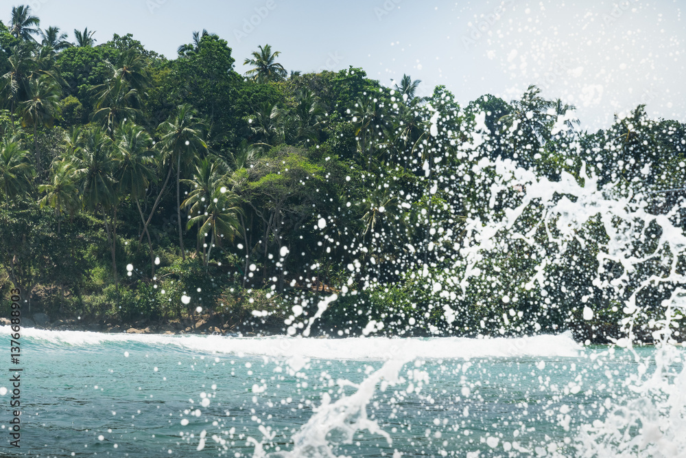 Tropical beach with palms tree and clear blue ocean splash for surf. Summer landscape, travel concept. Inside wave.