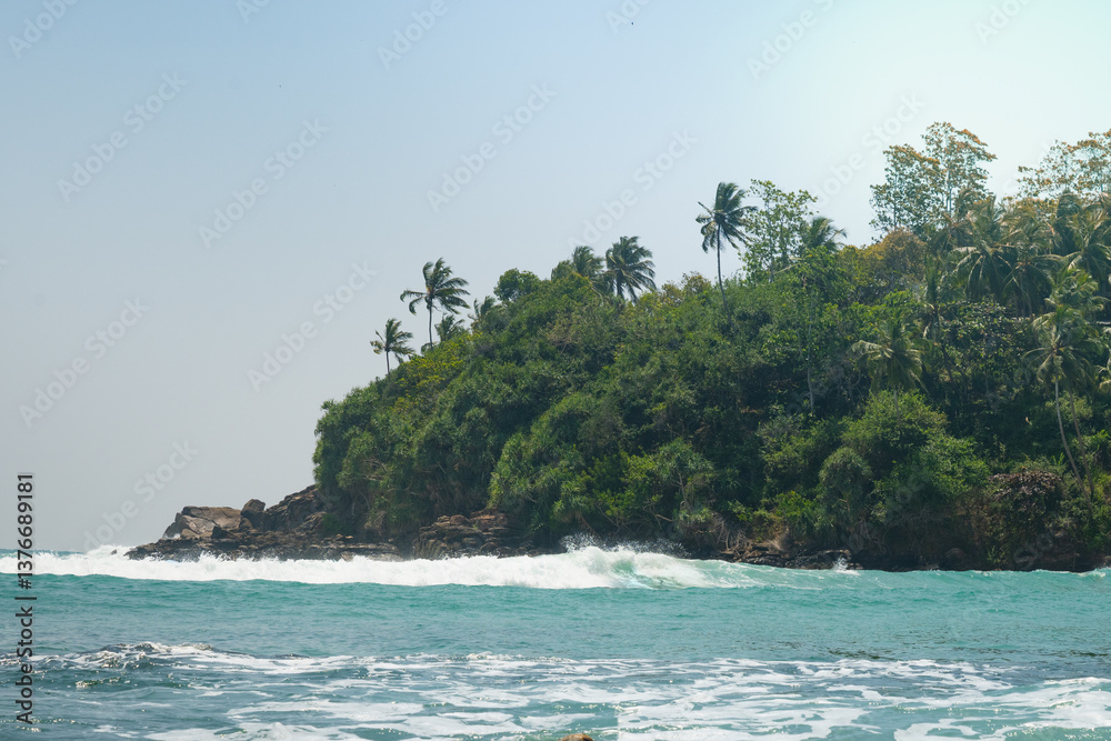 Tropical beach with palms and clear blue ocean for surf. Summer landscape, travel concept. Inside wave. World Ocean Day.