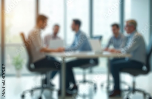 Blurred office meeting with businessmen at table, work process. Team discuss project, using laptop. Business meeting cooperation in workplace, modern corporate interior design, business people