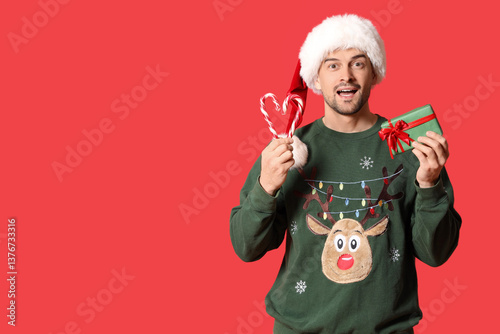 Handsome man in Santa hat w...