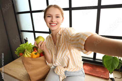 Young woman with paper bag ...
