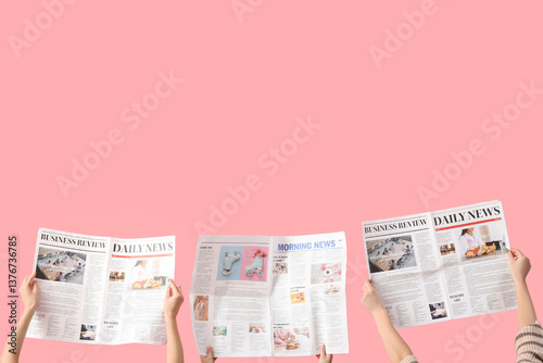 Women with newspapers on pink background