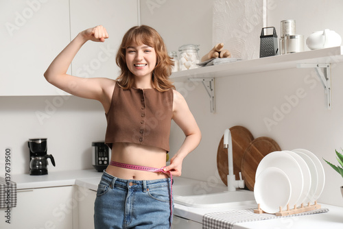Beautiful young woman measu...