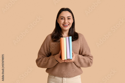 Smiling young woman holding...