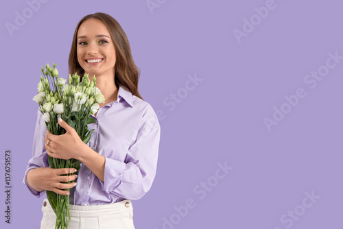 Smiling young woman holding...