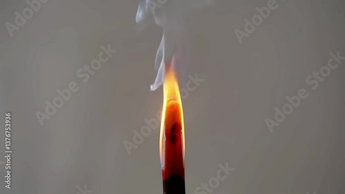 Burning incense stick, close-up, orange flame and white smoke, relaxation and meditation concept