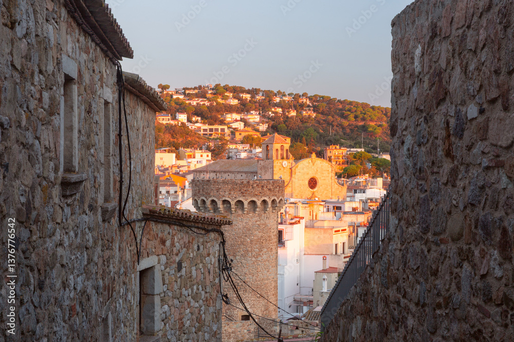Medieval stone towers and coastal village at sunrise in Tossa de Mar, Spain