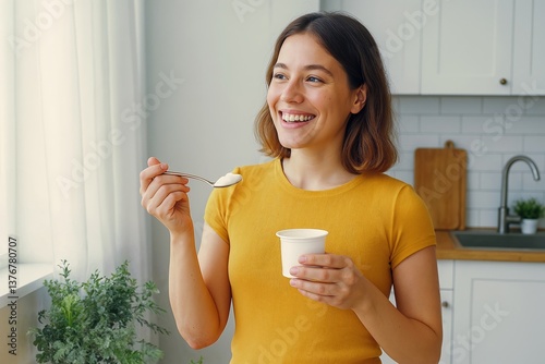 Smiling Woman Enjoying Yogurt in a Modern Home Kitchen Setting