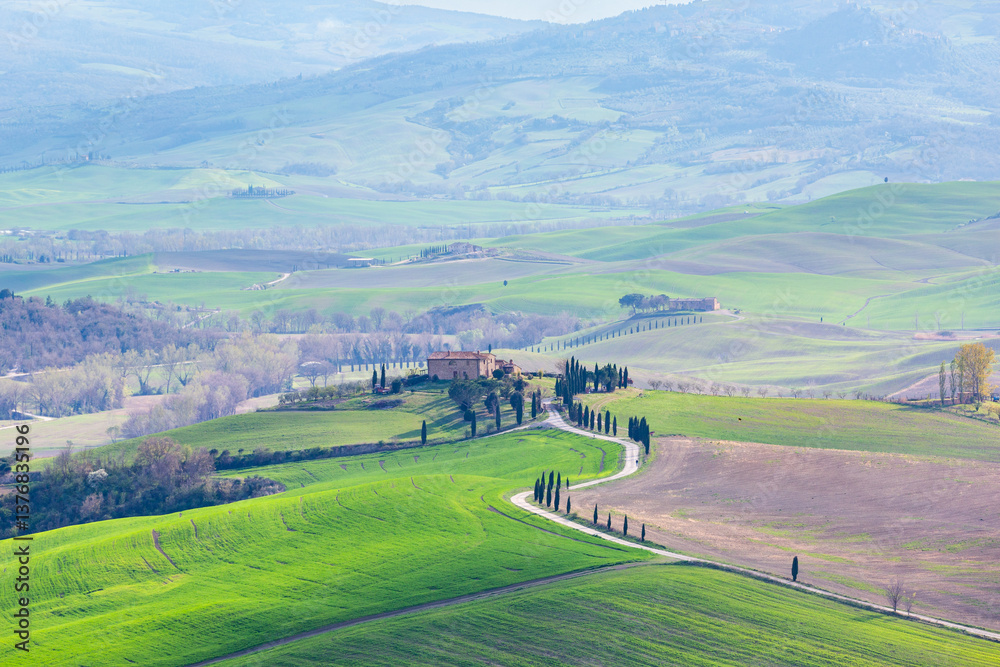 Tuscan landscape with rolling hills, cypress trees, and a farmhouse on a hilltop