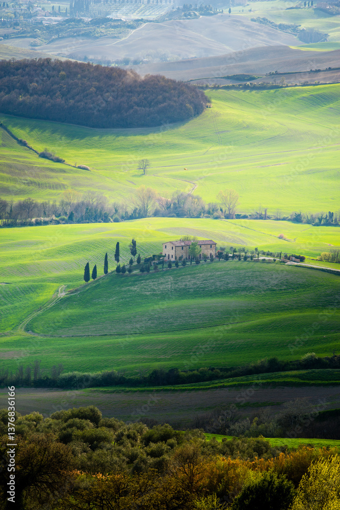 Tuscan farmhouse nestled among rolling green hills and cypress trees in Italy
