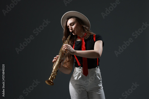 Canvas Print Musician playing soprano saxophone on grey background