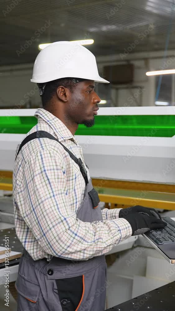 African American Operator Cutting OSB Panel by CNC African American Operator Cutting OSB Panel by CNC