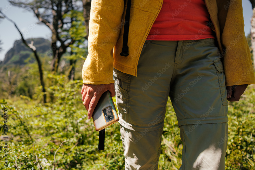 Close-Up of a Hiker Holding a Smartphone in Nature Close-Up of a Hiker Holding a Smartphone in Nature