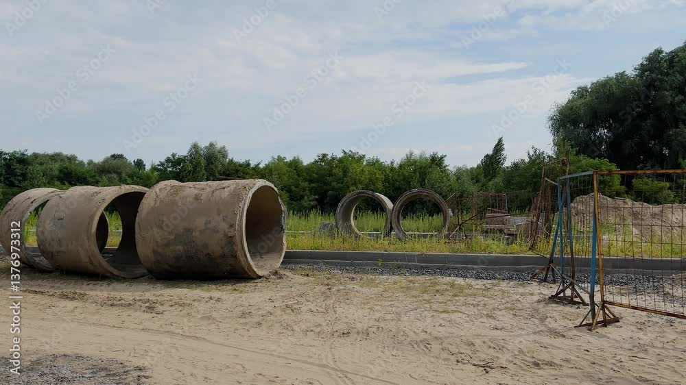 Concrete pipes on a road under construction Concrete pipes on a road under construction