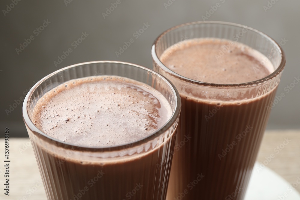Tasty chocolate milk in glasses on table, closeup Tasty chocolate milk in glasses on table, closeup