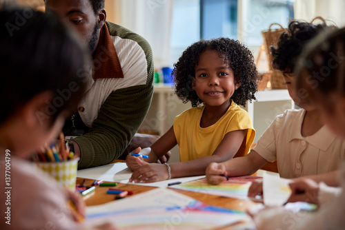 Portrait of cute smiling girl learning art at daycare