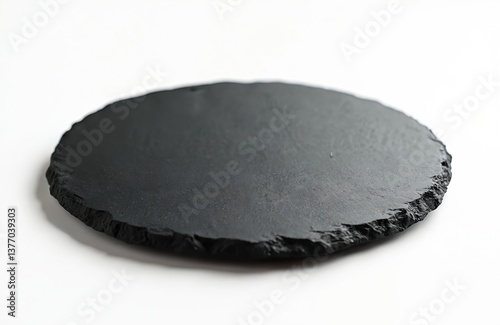 Empty round black graphite serving board isolated white background. Dark textured slate stone platter. Ideal for food presentation. Plate for restaurant, cafe, dining.