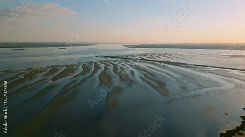 Aerial view of tidal sandbanks at low tide under soft evening light, creating patterns in the estuarine water. Location: Zeeland, Netherlands (Zeeland, Nederland)