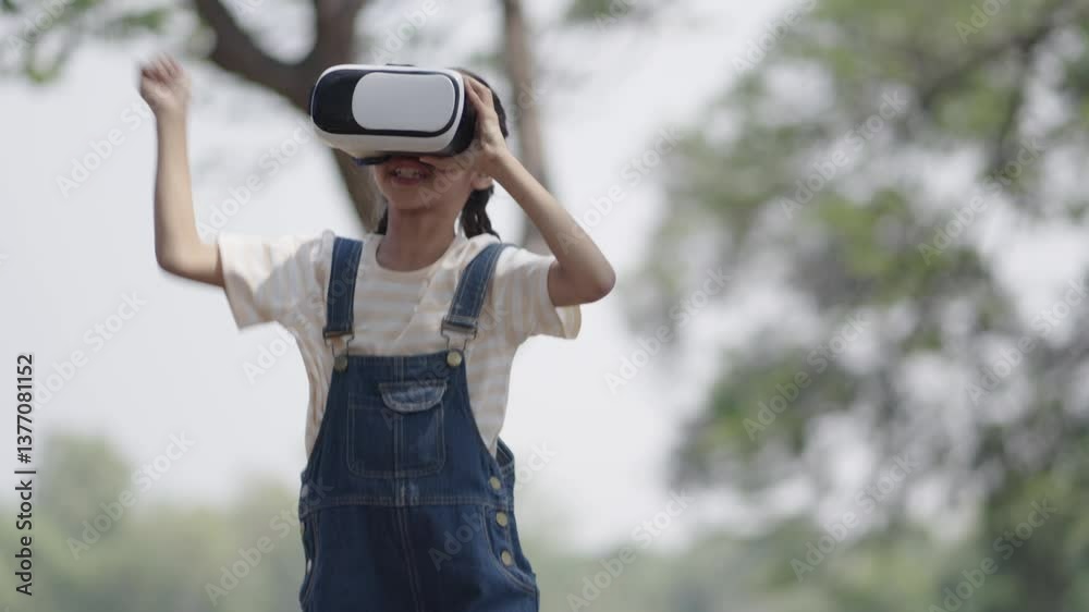 A little girl is wearing VR glasses for learning. A little girl is wearing VR glasses for learning.