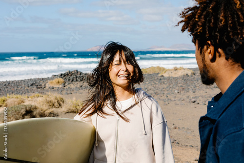 Surfers enjoying a casual chat during a group outing to the beach