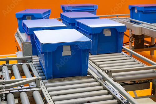 Plastic containers on conve...