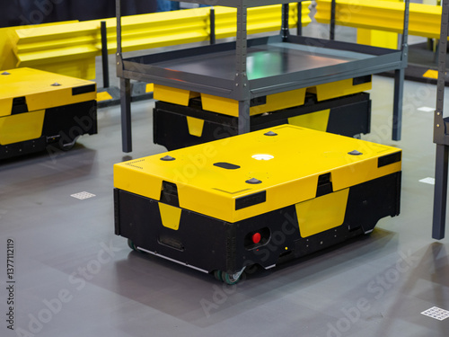 Robotic warehouse. AGV work in storage. Robots for moving warehouse racks. Robotic storage area. Yellow AGV for fulfillment. Industrial robots for warehouses. Automated guided vehicles