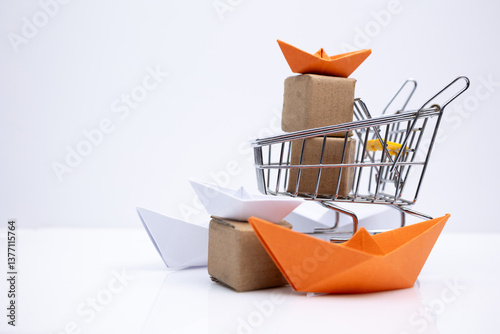 Shopping cart filled with boxes and paper boats on a white background.. Symbolizing e-commerce, modern commerce, sale and export.
