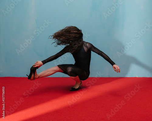Elegant Gesture of Artistic Dance Against Bold Red and Blue Back