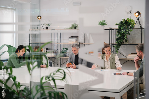 Collaborative meeting in a modern office with green decor photo