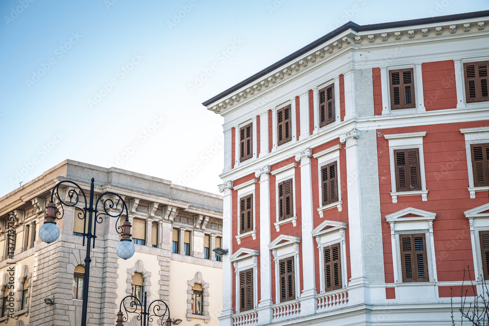 Fototapeta premium Traditional residential buildings in central Trieste, Italy, highlighting classic European architectural styles, reflecting local real estate and urban living.
