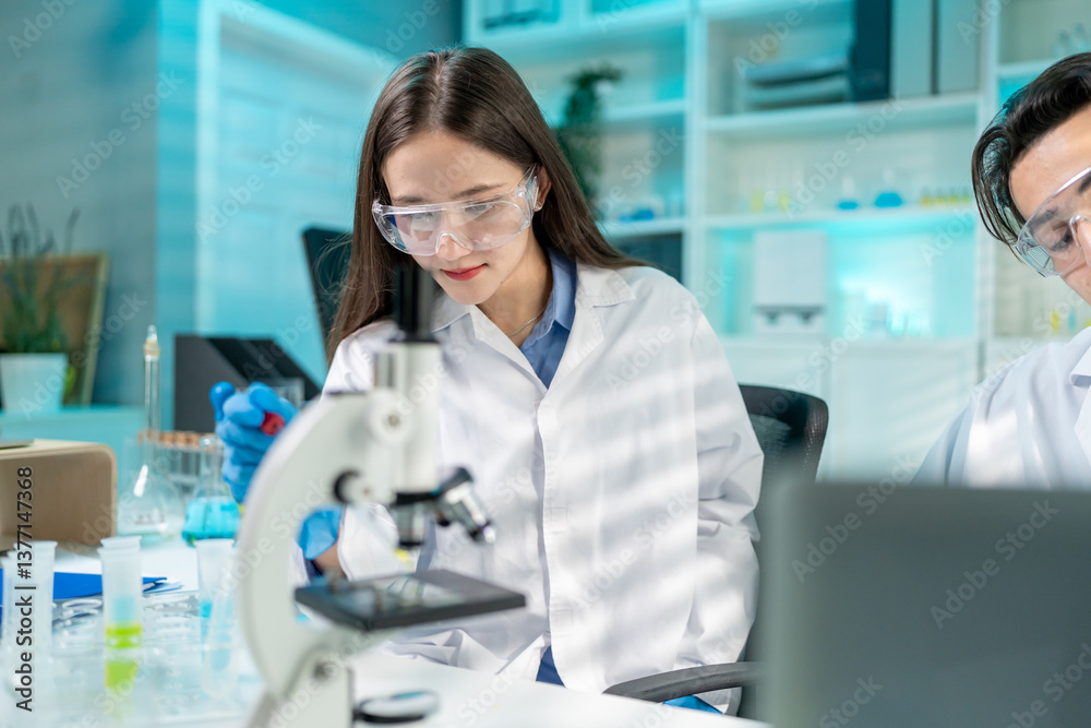 Asian female scientist working in biotechnology research laboratory. Asian female scientist working in biotechnology research laboratory.