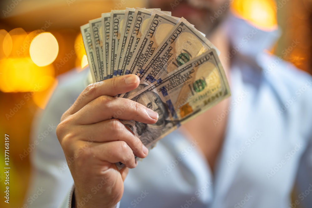 Rich businessman holding cash. Successful rich man counting dollar bills. Rich business man with dollar bills. Wealthy man showing dollars money. Rich man holding banknotes. Financial success. Riches.