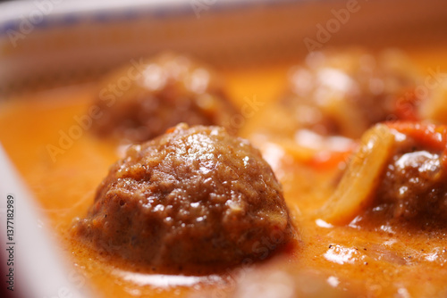 Принти на полотні Meatballs simmering in rich sauce at a cozy kitchen