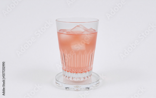 Wallpaper Mural Refreshing pink drink with ice cubes in a clear glass. Placed on a coaster against a clean white background. Simple and thirst-quenching beverage. Torontodigital.ca