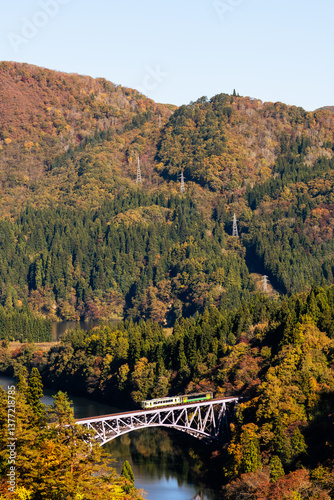 Fukushima, JAPAN - Nov 10, 2024: Train run cross Daichi Tagamigawa Bridge view from First Tadami River Bridge