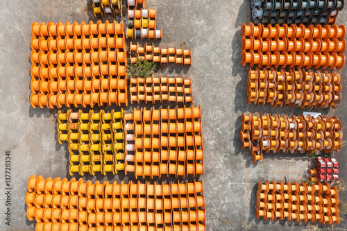 Aerial view of stacked empty orange and yellow cable spools. photo